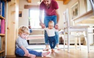 Man helping baby walk. Pediatric Foot & Ankle, Gilbert AZ