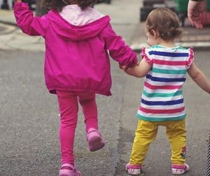 Two children holding hands